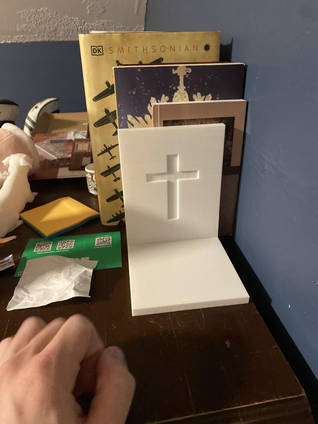 Cross bookend holding books